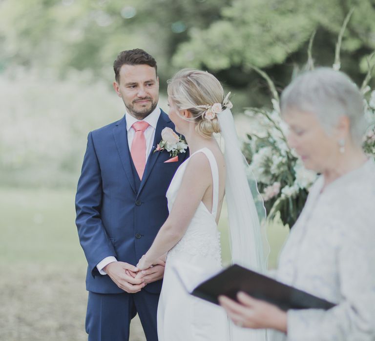 Wedding Ceremony | Bride in Justin Alexander Gown | Groom in Moss Bros Suit | Outdoor Peach Wedding at Courteenhall House in Northamptonshire Planned by Your Story Events | Ferri Photography