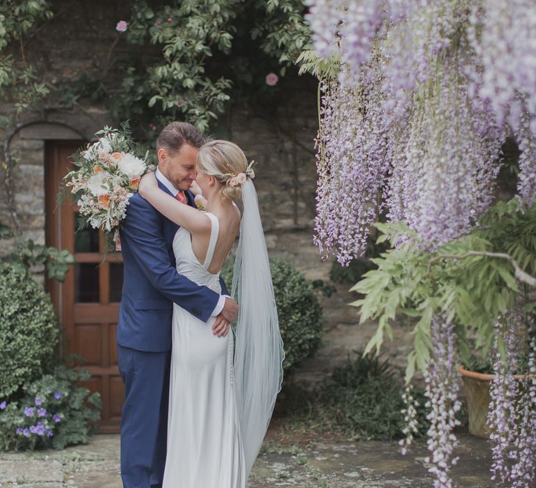 Bride in Justin Alexander Gown | Groom in Moss Bros Suit | Outdoor Peach Wedding at Courteenhall House in Northamptonshire Planned by Your Story Events | Ferri Photography