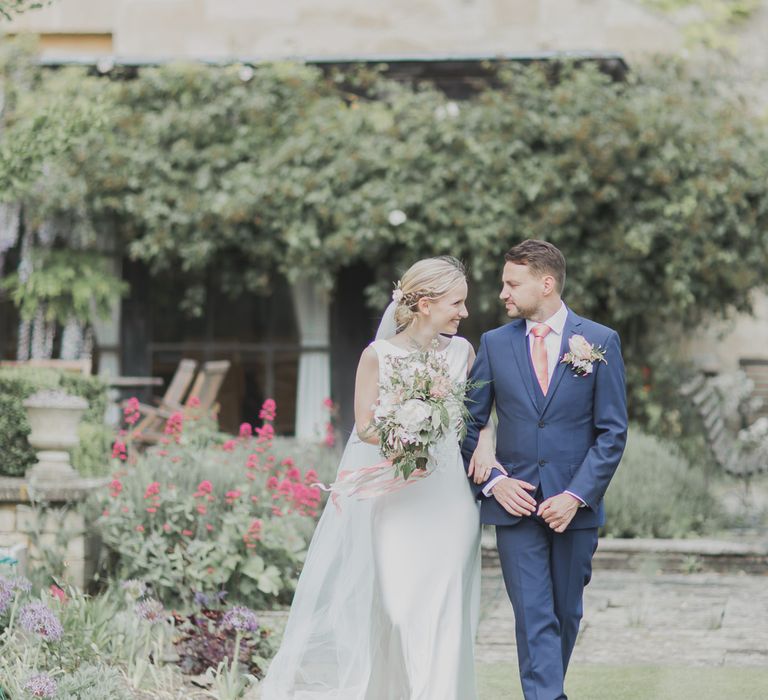 Bride in Justin Alexander Gown | Groom in Moss Bros Suit | Outdoor Peach Wedding at Courteenhall House in Northamptonshire Planned by Your Story Events | Ferri Photography