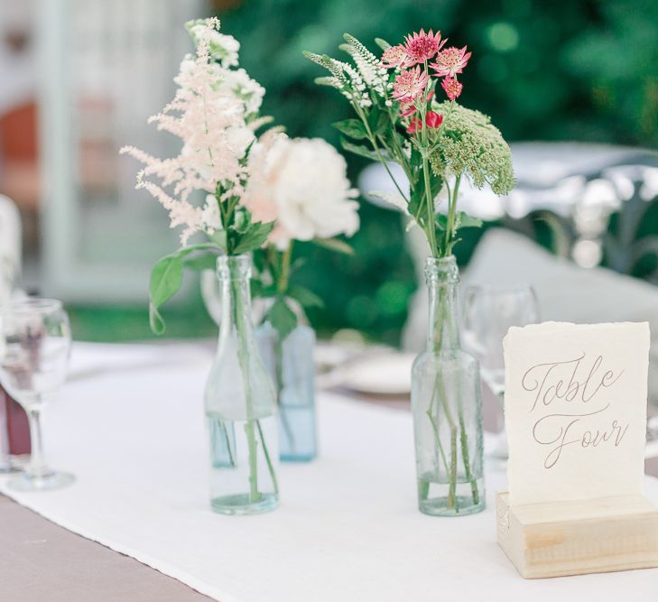 Flower Stems in Bottles | Secret Garden Reception at Castle Cottage Cafe, Oakham | White Stag Wedding Photography