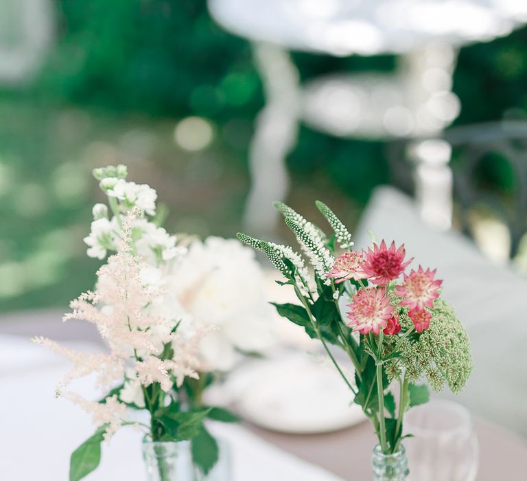 Flower Stems in Bottles | Secret Garden Reception at Castle Cottage Cafe, Oakham | White Stag Wedding Photography