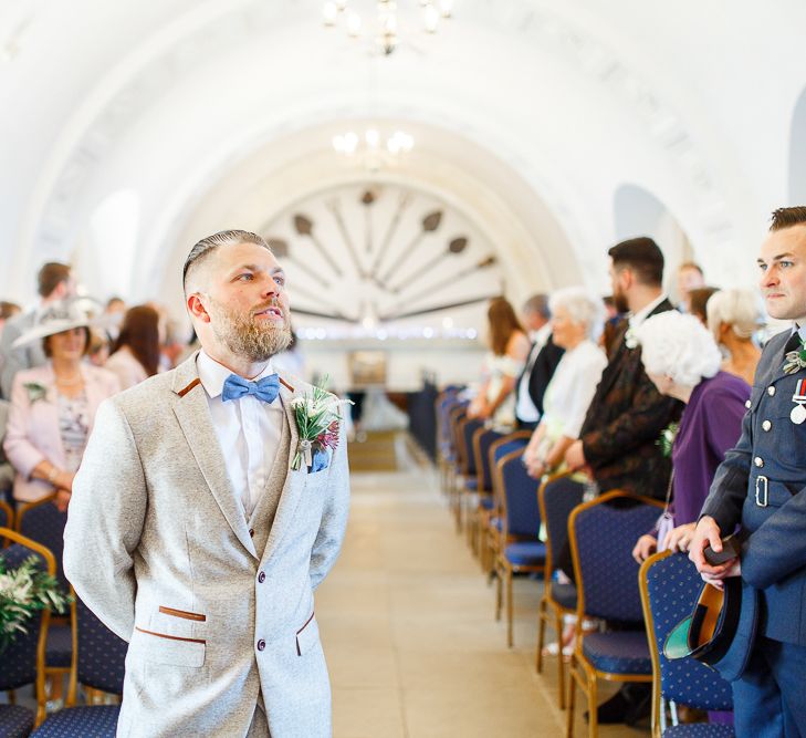 Wedding Ceremony at Normanton Church on Rutland Water | Groom in Cream Herringbone Tweed Suit from Marc Darcy | White Stag Wedding Photography