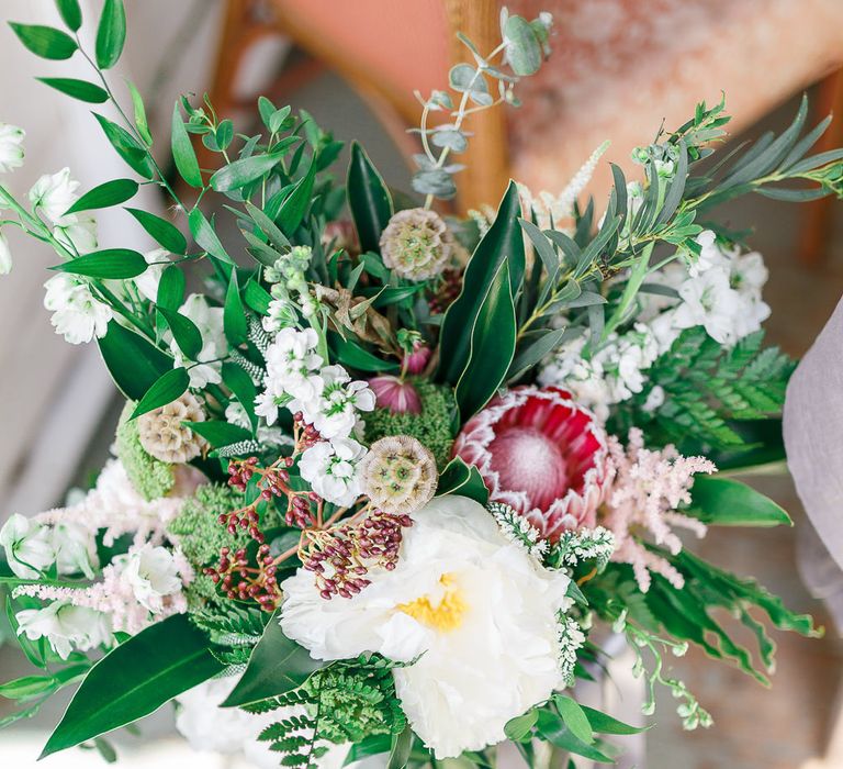 Organic Bridal Bouquet with Protea Flower | Secret Garden Reception at Castle Cottage Cafe, Oakham | White Stag Wedding Photography