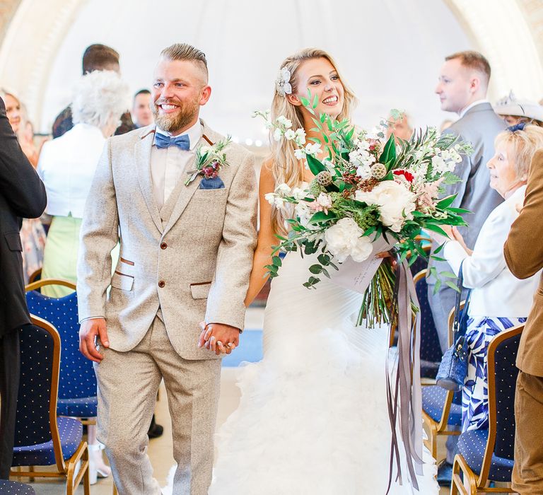 Wedding Ceremony at Normanton Church on Rutland Water | Pronovias Wedding Dress | Groom in Cream Herringbone Tweed Suit from Marc Darcy | White Stag Wedding Photography