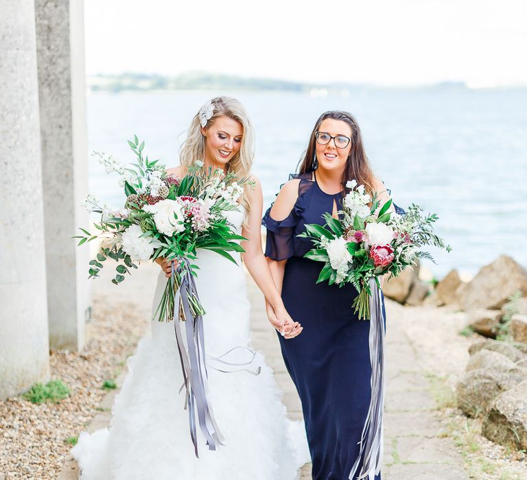 Bride in Pronovias Wedding Dress | Bridesmaid in Navy Dress | Normanton Church on Rutland Water | White Stag Wedding Photography