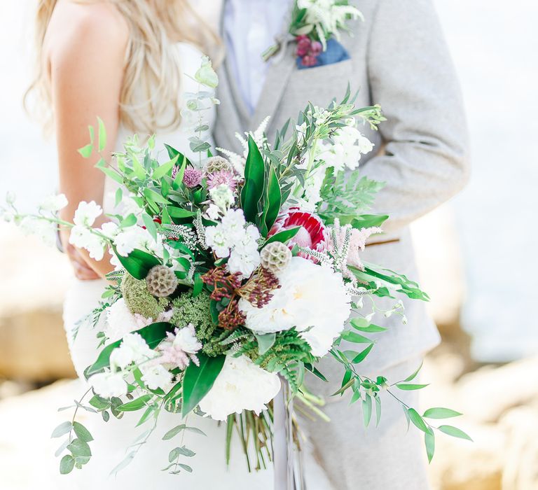 Bride in Pronovias Wedding Dress | Groom in Cream Herringbone Tweed Suit from Marc Darcy | Normanton Church on Rutland Water | White Stag Wedding Photography