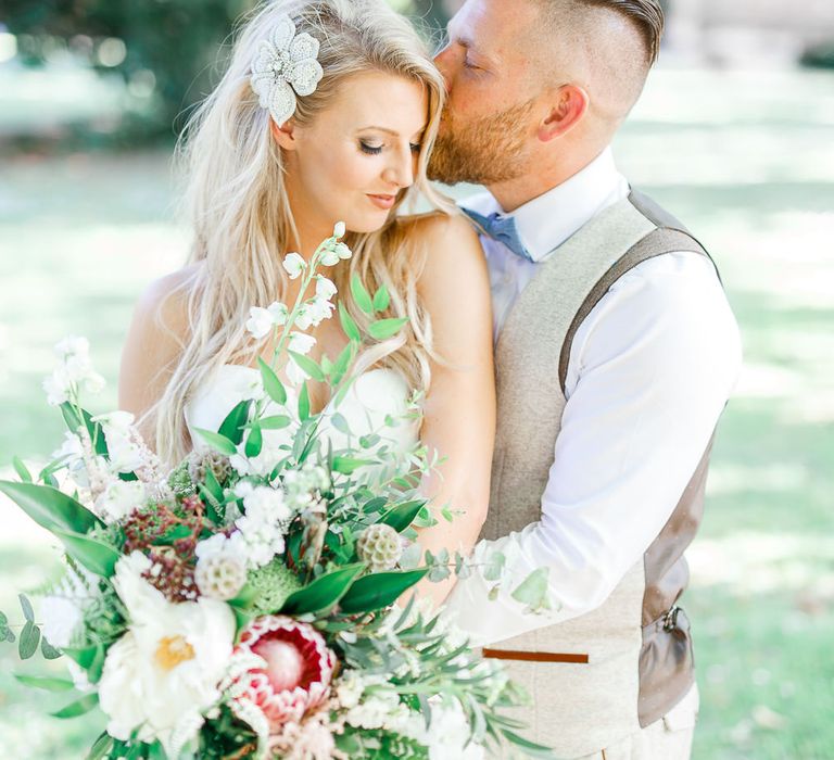 Bride in Pronovias Wedding Dress | Groom in Cream Herringbone Tweed Suit from Marc Darcy | Normanton Church on Rutland Water | White Stag Wedding Photography