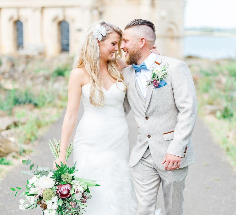 Bride in Pronovias Wedding Dress | Groom in Cream Herringbone Tweed Suit from Marc Darcy | Normanton Church on Rutland Water | White Stag Wedding Photography