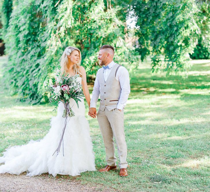 Bride in Pronovias Wedding Dress | Groom in Cream Herringbone Tweed Suit from Marc Darcy | Normanton Church on Rutland Water | White Stag Wedding Photography