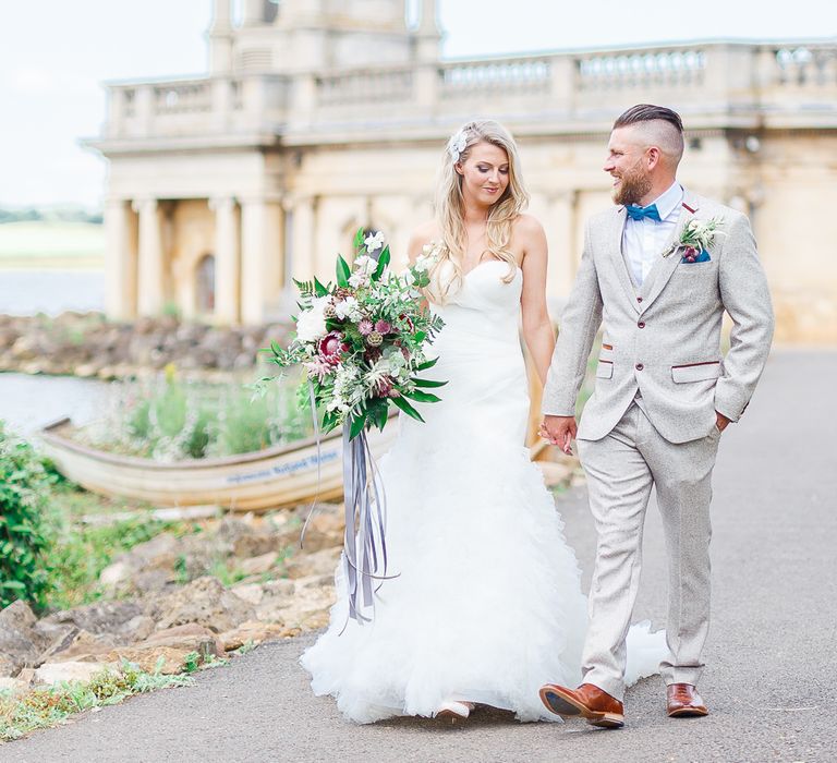 Bride in Pronovias Wedding Dress | Groom in Cream Herringbone Tweed Suit from Marc Darcy | Normanton Church on Rutland Water | White Stag Wedding Photography