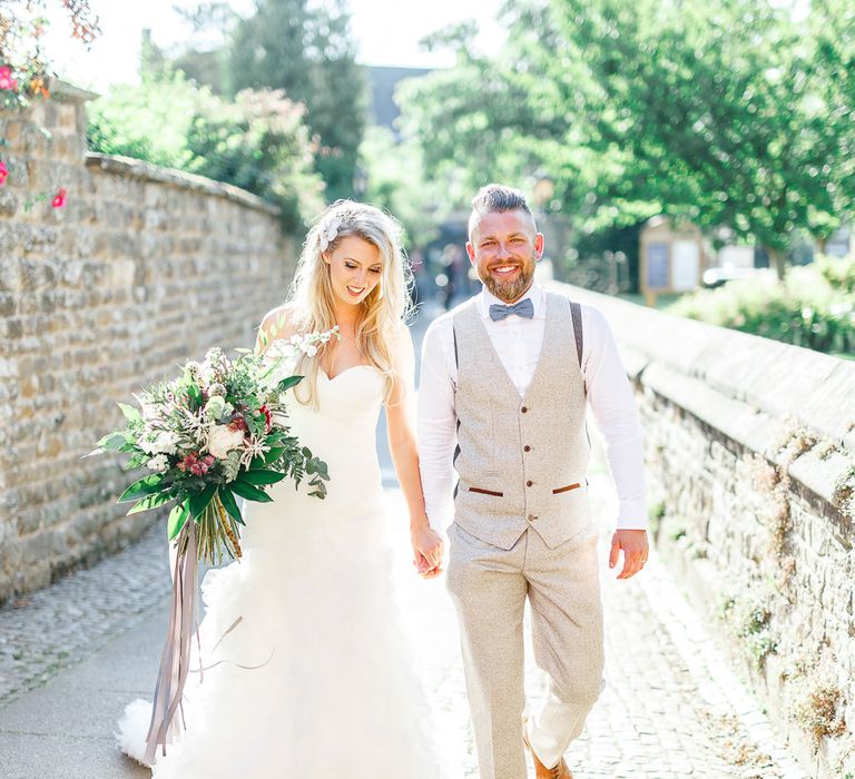 Bride in Pronovias Wedding Dress | Groom in Cream Herringbone Tweed Suit from Marc Darcy | Normanton Church on Rutland Water | White Stag Wedding Photography