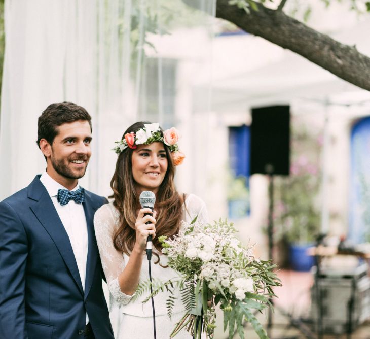 Spanish Outdoor Wedding Ceremony | Boho Bride in Veronica Miranda Bridal Separates & Flower Crown & Groom in Navy Suit & Bow Tie