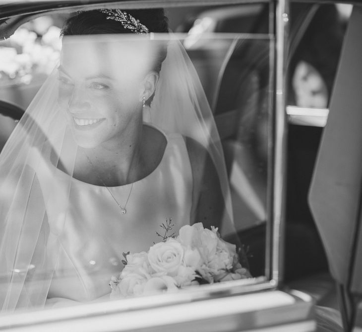 Bride in Tom Flowers Dress, Long Satin Gloves & Ivory & Co. Headdress in the Wedding Car