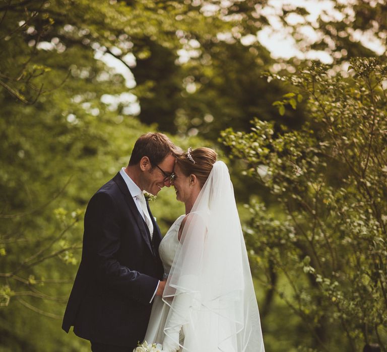 Bride in Tom Flowers Dress, Long Satin Gloves & Ivory & Co. Headdress and Groom in Moss Bros Suit