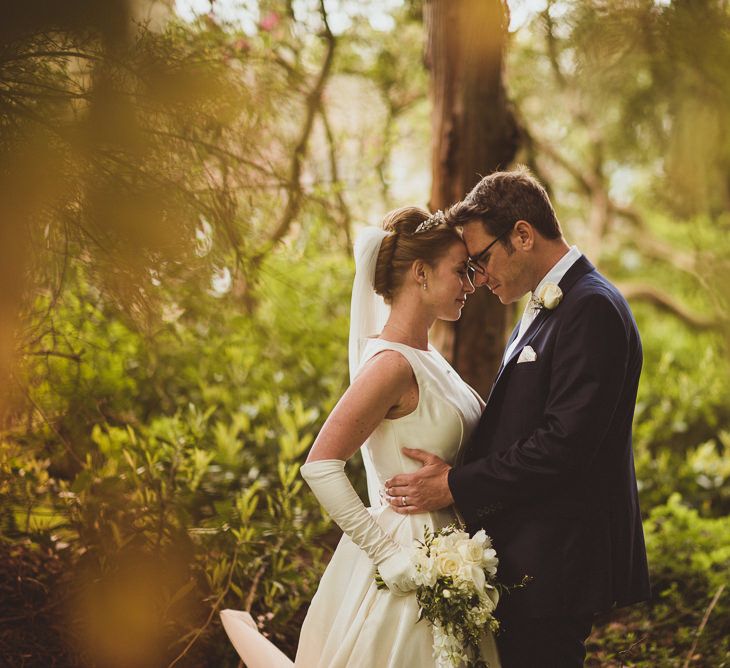 Bride in Tom Flowers Dress, Long Satin Gloves & Ivory & Co. Headdress and Groom in Moss Bros Suit