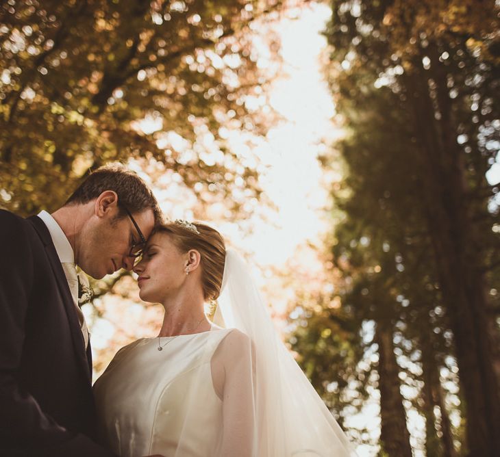 Bride in Tom Flowers Dress, Long Satin Gloves & Ivory & Co. Headdress and Groom in Moss Bros Suit