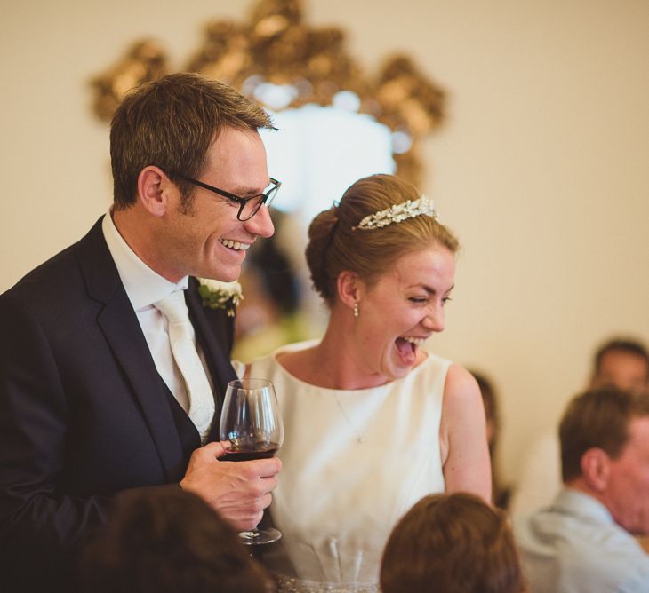 Bride in Tom Flowers Dress, Long Satin Gloves & Ivory & Co. Headdress and Groom in Moss Bros Suit