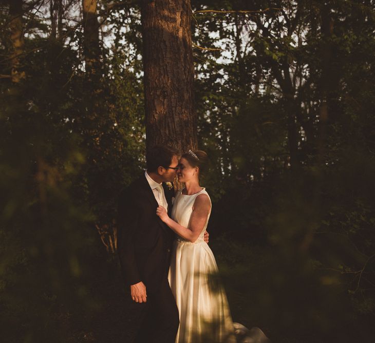 Bride in Tom Flowers Dress, Long Satin Gloves & Ivory & Co. Headdress and Groom in Moss Bros Suit