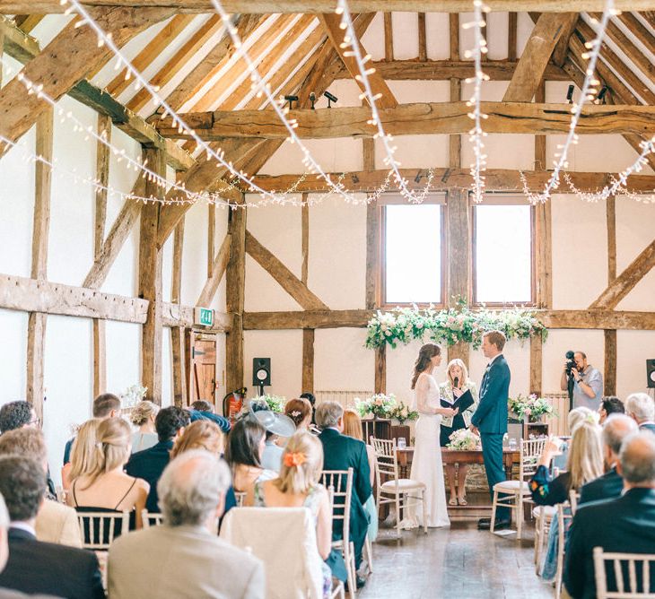 Wedding Ceremony | Bride in Fred & Ginger Bridal Design Gown | Groom in Navy Mullen Mullen Suit | Pastel Spring Wedding at Loseley Park Barn | Sarah-Jane Ethan Photography | Captured Media Weddings Film