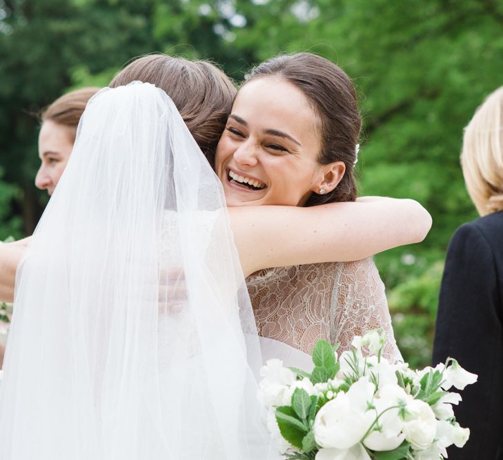 Wedding Guest Hugs | Bride in Ingrida Bridal Gown | Beautiful Classic Wedding at Cornwell Manor | Lucy Davenport Photography