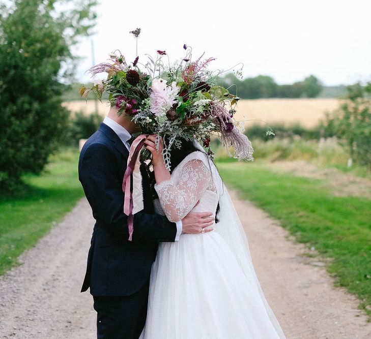 Red & Green Oversized Bouquet | Boho Bride in Naomi Neoh Gown | Groom in Hackett Suit | Natalie Hewitt Planned Wedding at Normanton Church & Kingsthorpe Lodge Barn | Jeni Smith Photography | Blue Ridge Wedding Videography