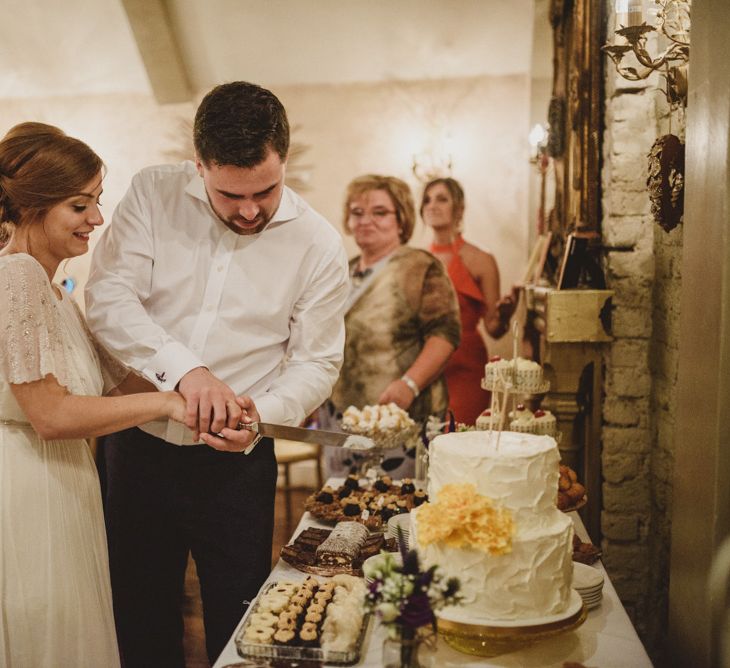 Cutting the Cake | Bride in Saja Wedding Dress | Groom in Louis Copeland Suit | Antonija Nekic Photography