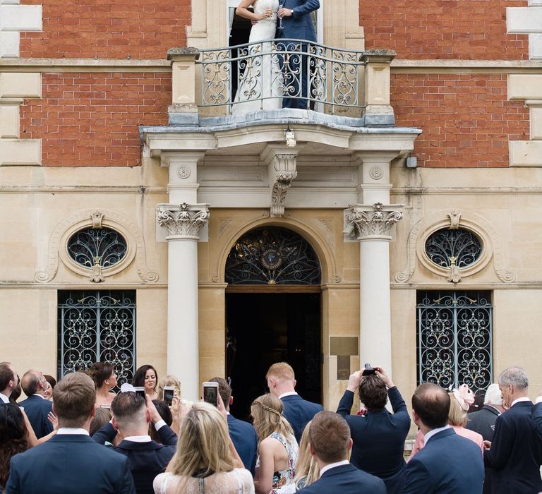 Bride & Groom Balcony Kiss at Fetcham Park in Surrey