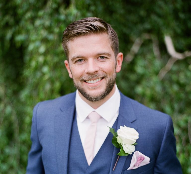 Groom in Reiss Three Piece Navy Suit