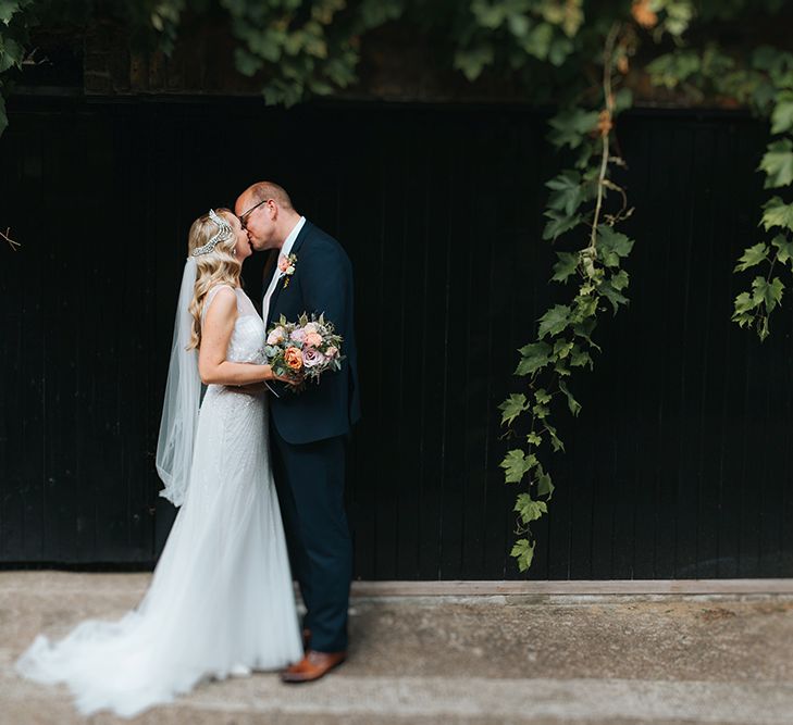 Bride in Rosa Clara Veleta Wedding Dress & Groom in Chester Barrie Suit