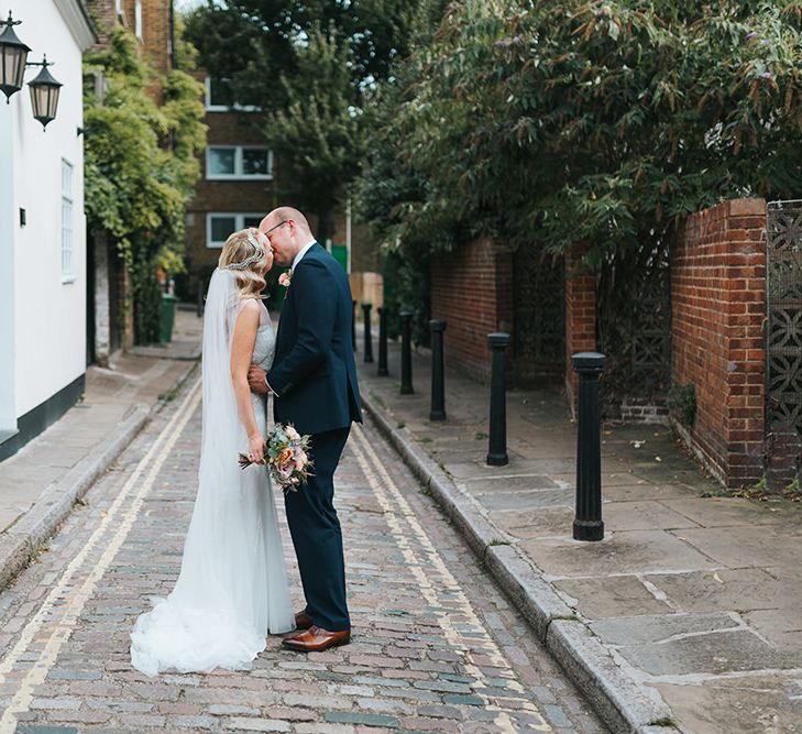 Bride in Rosa Clara Veleta Wedding Dress & Groom in Chester Barrie Suit