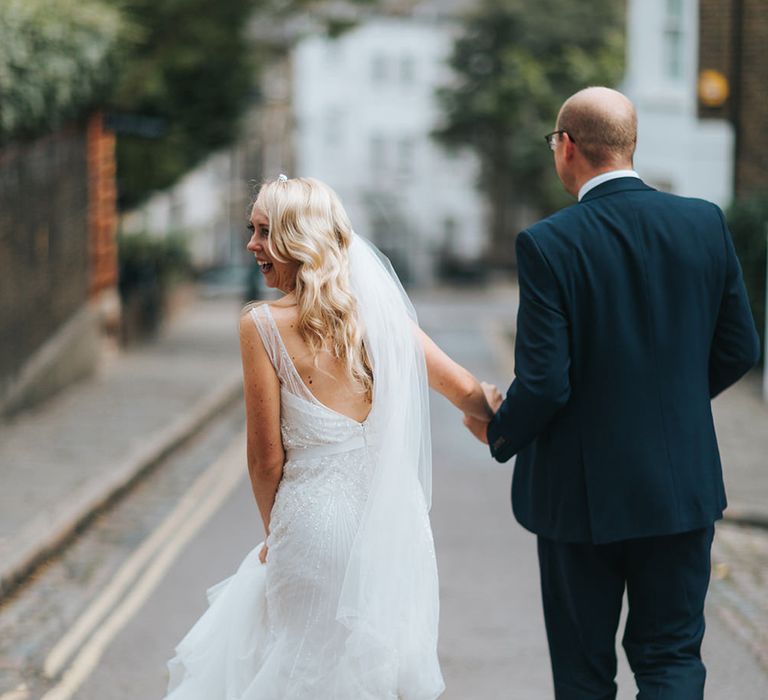 Bride in Rosa Clara Veleta Wedding Dress & Groom in Chester Barrie Suit