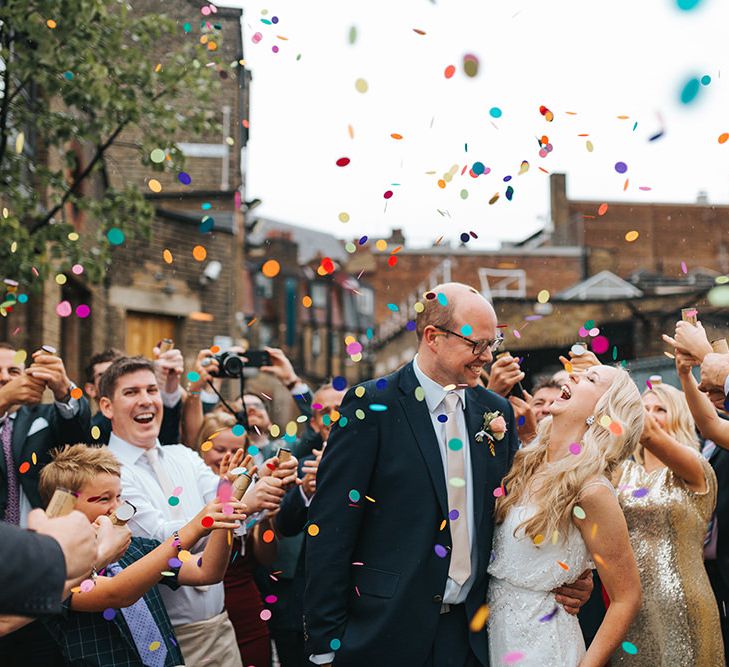 Bride in Rosa Clara Veleta Wedding Dress & Groom in Chester Barrie Suit Confetti