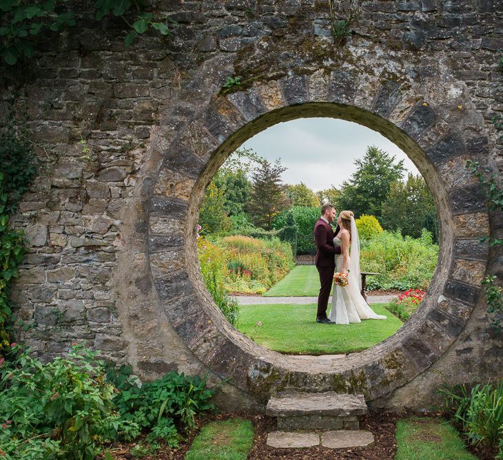 Bride in Lace Sweetheart Neckline Dress | Groom in Burgundy Suit | Kathy Silke Photography