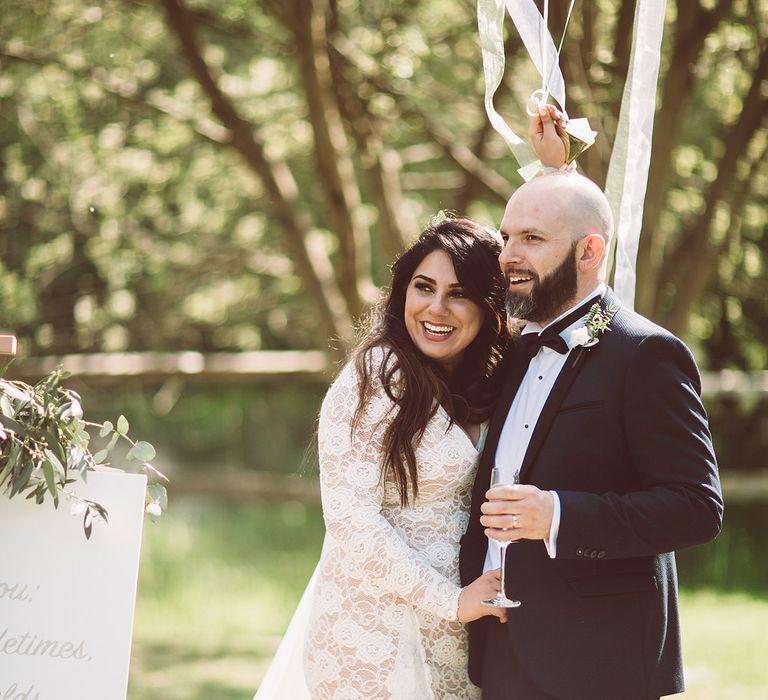 Bride in Grace Loves Lace Wedding Dress | Groom in Tuxedo | Giant Balloons | Lemonade Pictures