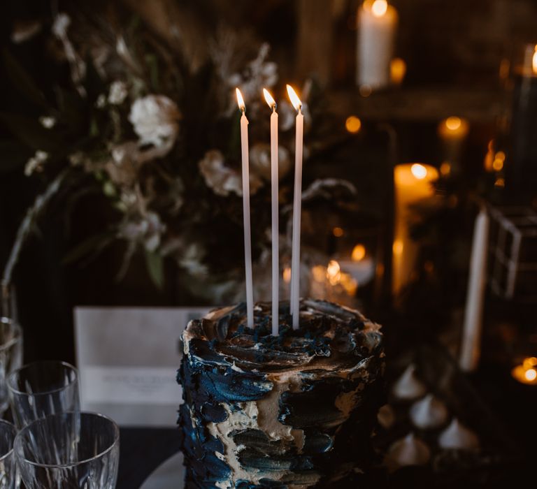 Inky Blue Buns of Fun Bakery Cake with Taper Candles | Nocturn Wedding Inspiration at Godwick Great Barn Planned & Styled by The Little Lending Company | Agnes Black Photography | Film by The Wilde Bride