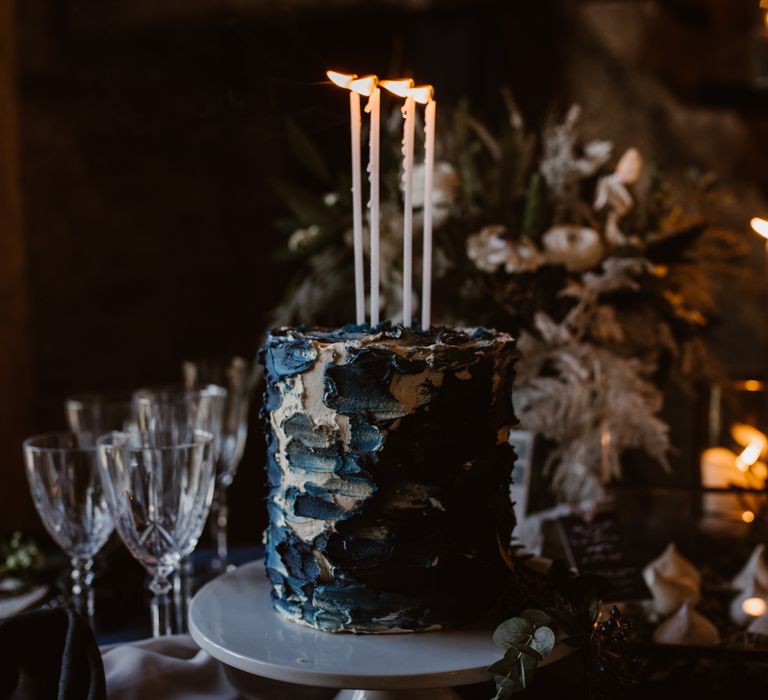 Inky Blue Buns of Fun Bakery Cake with Taper Candles | Nocturn Wedding Inspiration at Godwick Great Barn Planned & Styled by The Little Lending Company | Agnes Black Photography | Film by The Wilde Bride