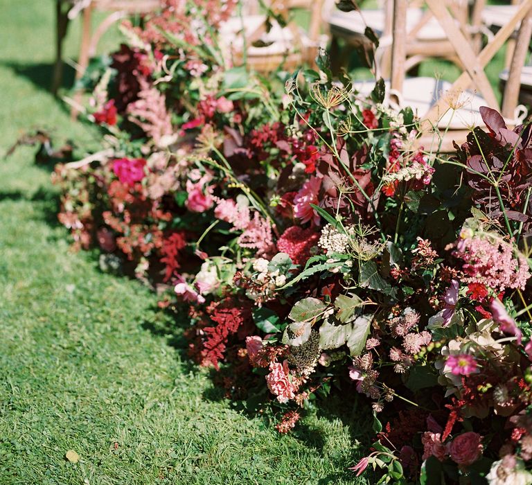 Rich Aisle Wedding Flowers by Martha & the Meadow | Opulent Wedding Inspiration at Warmwell House in Dorset with Rich colour Palette Planned by Kelly Chandler | Imogen Xiana Photography | Gorgeous Films