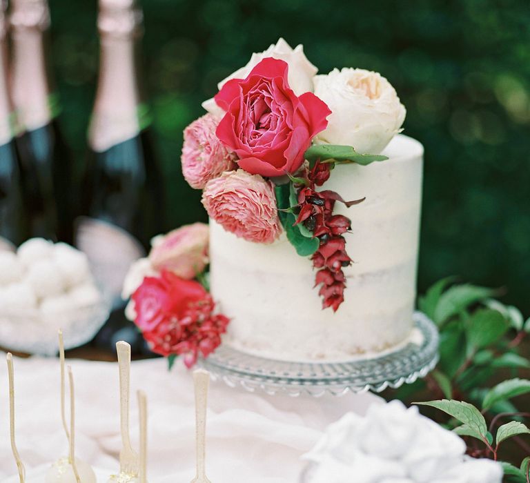 Iced Wedding Cake with Floral Decor by France Buns | Opulent Wedding Inspiration at Warmwell House in Dorset with Rich colour Palette Planned by Kelly Chandler | Imogen Xiana Photography | Gorgeous Films