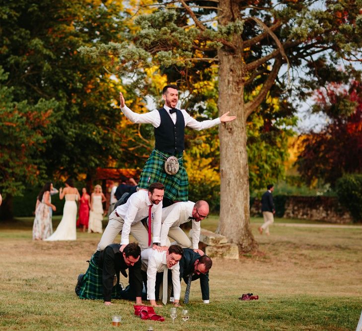 Human Pyramid | Groom in Tartan Kilt | Outdoor Wedding at Chateau Rigaud in France | Real Simple Photography | Yellow Gazelle Film