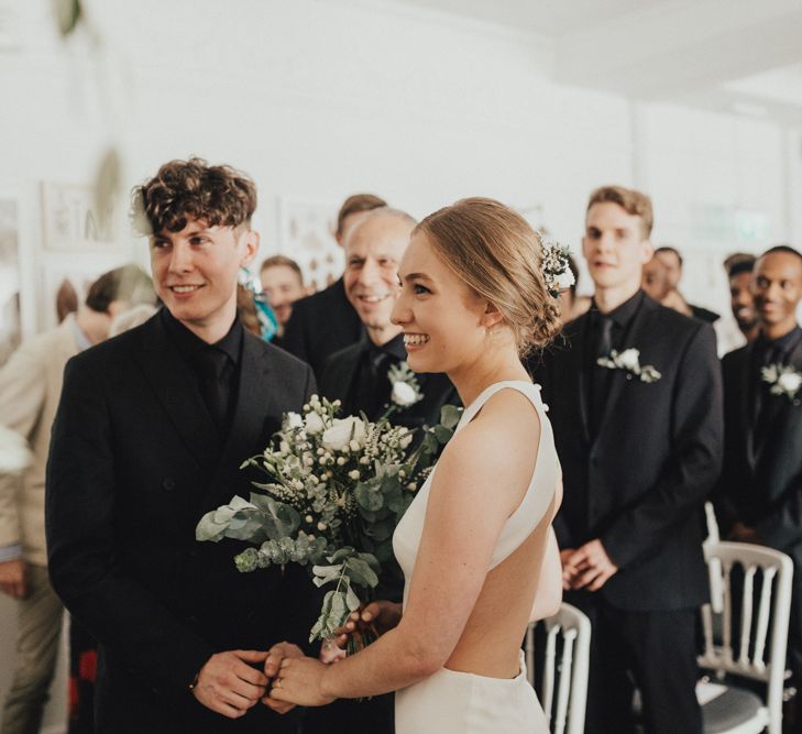 Bride In Sarah Seven Dress & Groom In All Black With Bridesmaids In White Shift Dresses And Foliage Decor With Images By Nataly J Photography