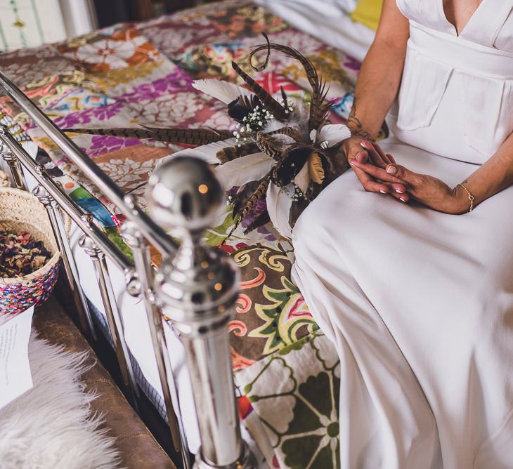 Bride in Ghost Bridal Gown with Feather Bouquet