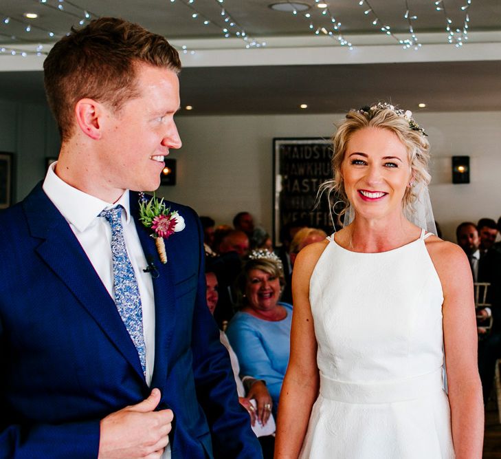 Wedding Ceremony | Bride in Jesus Peiro Wedding Dress | Groom in Navy Ted Baker Suit | Colourful Coastal Wedding at The Gallivant in Camber Sands with DIY Decor | Epic Love Story Photography