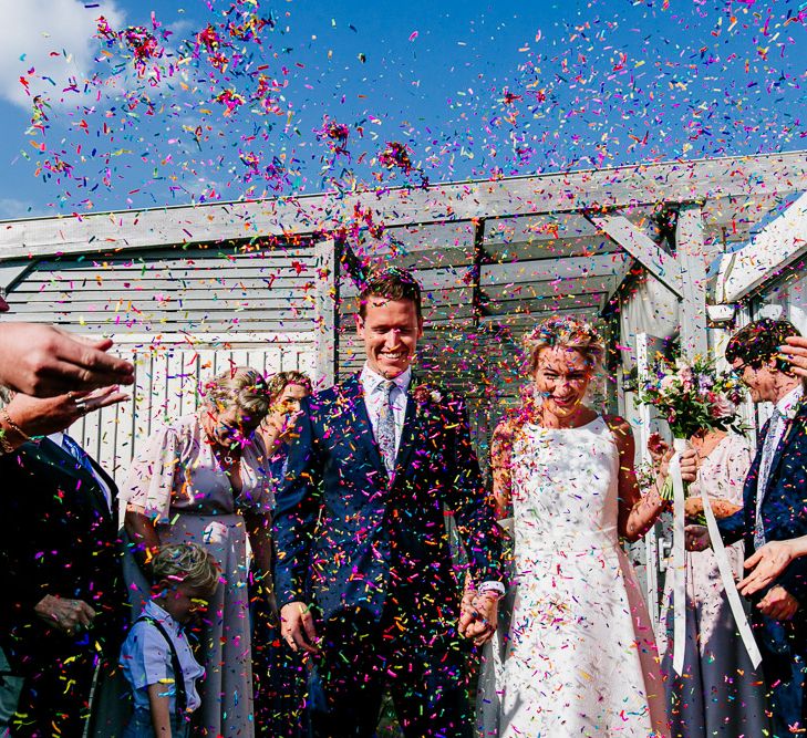 Confetti Exit | Bride in Jesus Peiro Wedding Dress | Groom in Navy Ted Baker Suit | Colourful Coastal Wedding at The Gallivant in Camber Sands with DIY Decor | Epic Love Story Photography