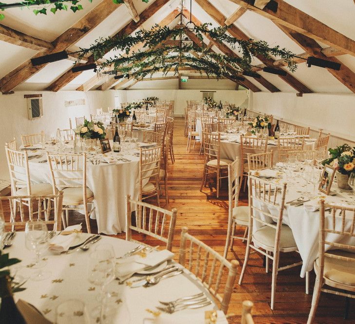 Rustic Barn Reception with Greenery Ceiling Decor