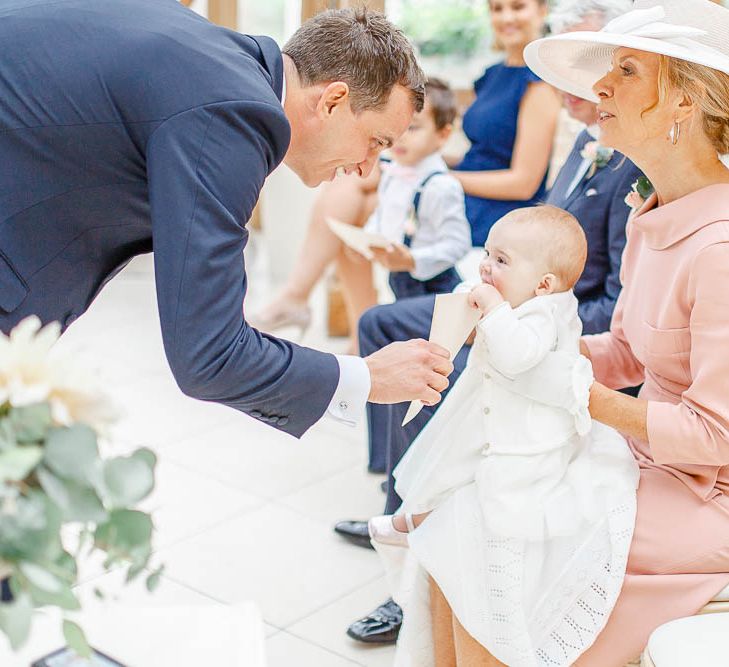 Groom in Navy Suit ^ Baby | Elegant Pastel Wedding at Gaynes Park, Essex | White Stag Wedding Photography | At Motion Film