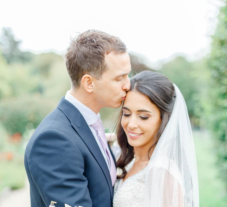 Bride in Lace Gown from Blackburn Bridal | Groom in Navy Three-piece Suit | Elegant Pastel Wedding at Gaynes Park, Essex | White Stag Wedding Photography | At Motion Film