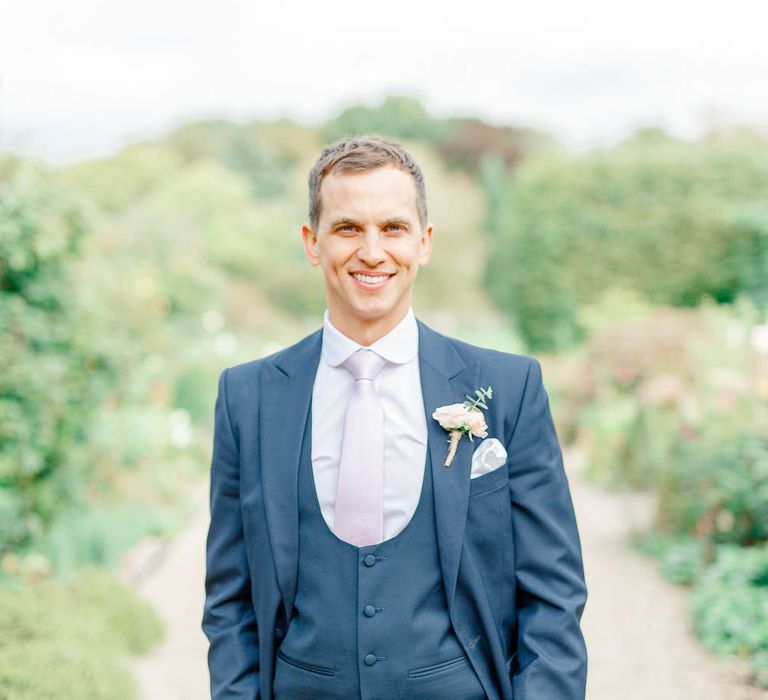 Groom in Navy Three-piece Suit | Elegant Pastel Wedding at Gaynes Park, Essex | White Stag Wedding Photography | At Motion Film