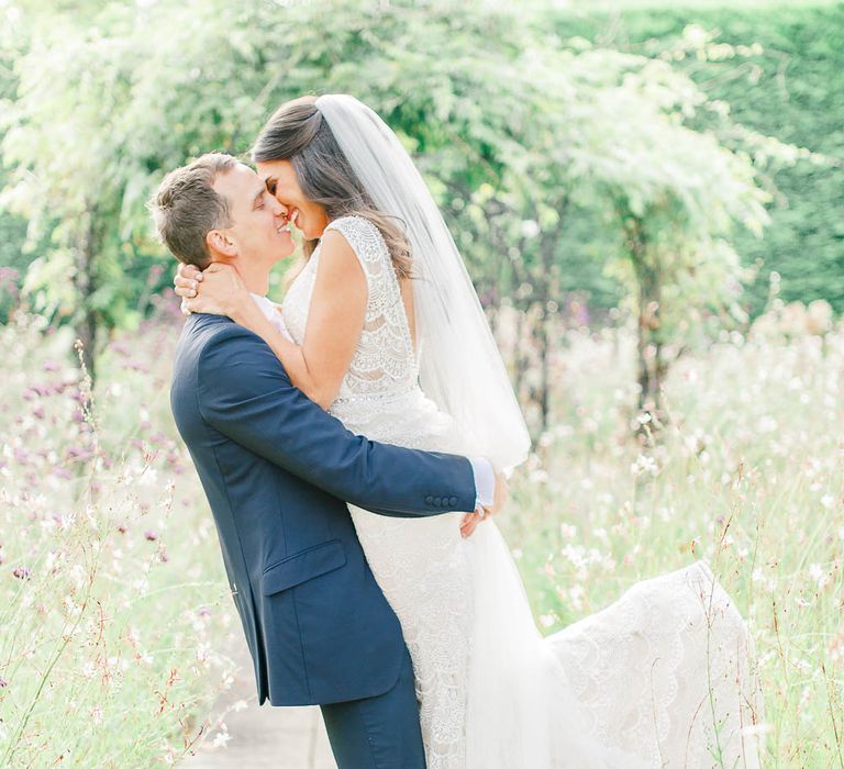 Bride in Lace Gown from Blackburn Bridal | Groom in Navy Three-piece Suit | Elegant Pastel Wedding at Gaynes Park, Essex | White Stag Wedding Photography | At Motion Film