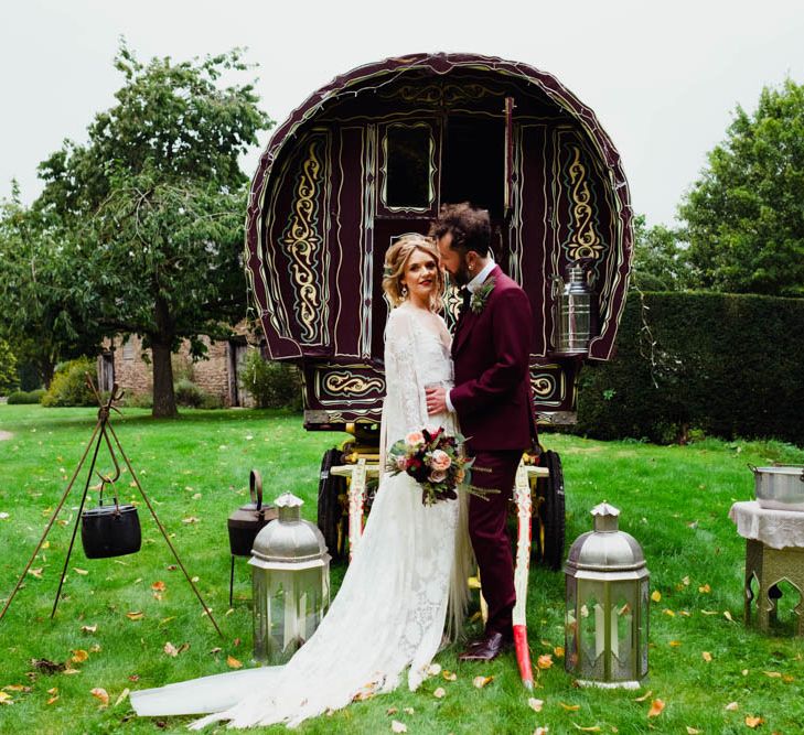 Gypsy Caravan Backdrop | Bride in Rue de Seine Cleo Wedding Dress | Groom in Burgundy Suit | Outdoor Wedding at Dewsall Court Oxfordshire | Claudia Rose Carter Photography | Costa Sister Productions