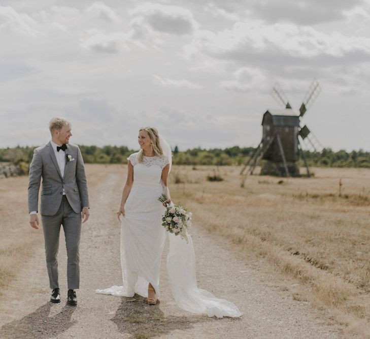 Bride in By Malina Bridal Gown & Groom in Grey Tiger of Sweden Suit